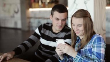 Kadın ve konuşmak ve seyir telefon el kafede oturan adam