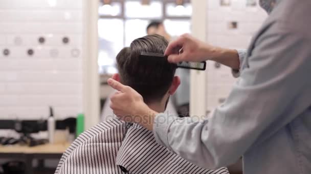 Barbeiro adicionando cera e penteando cliente . — Vídeo de Stock