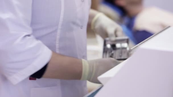 Zubaři se nástroje ze sterilizátoru a přijďte do pacienta — Stock video