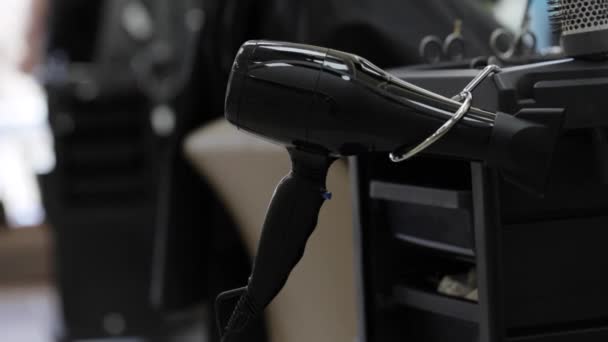 Close-up tiro de cabeleireiro leva um secador de cabelo — Vídeo de Stock