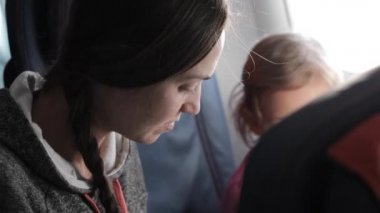 Küçük kızı uçağa yolculuk ile genç çekici kadın.