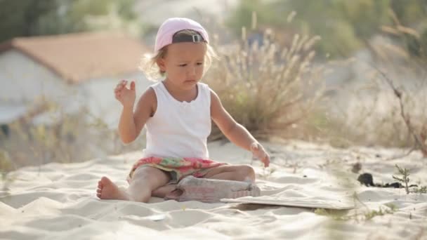 Little charming baby girl playing with sand without toys — Stock Video