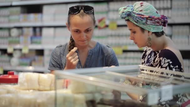 İki genç kadının süpermarkette alışveriş bölümünde baharat seçme — Stok video