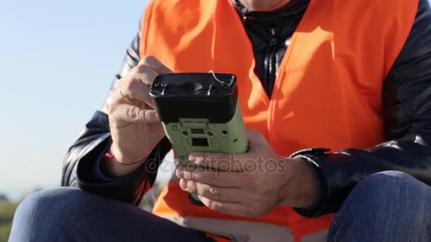 Обрізане зображення людини, що працює з геодезичним обладнанням — стокове відео