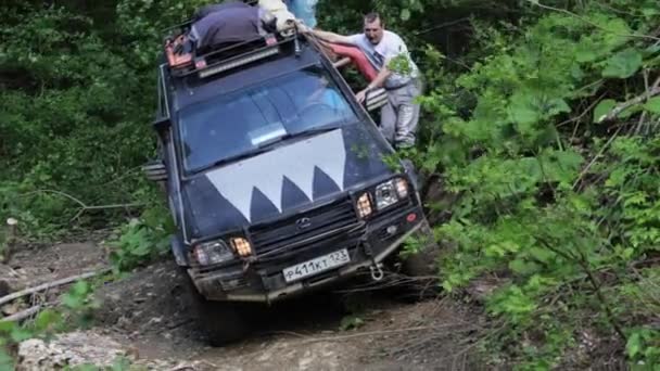 Expeditionary SUV driving slowly through dangerous area at forest. — Stock Video