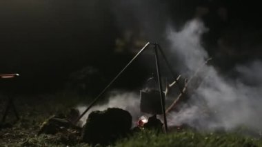 Kazan gece kamp ateşi. Çocuk Yangın için çalışır.