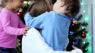 Mutlu anne Noel ağacının yanındaki Noel zamanında çocukları ile eğlenmek