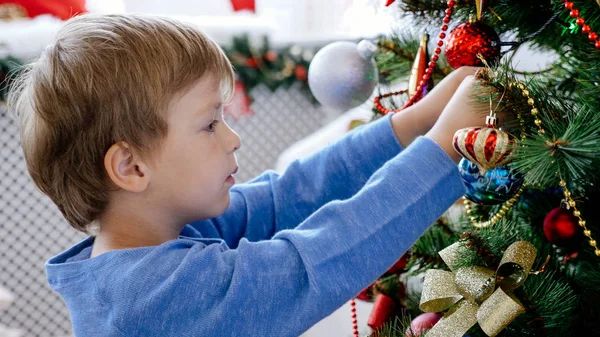 Close-up portrait of child decorating Christmas tree, closeup — Stock Photo, Image