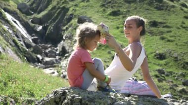 Anne ve kızı büyük taş üzerinde dinlenme gezi seyahat.