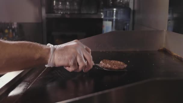 Chef cooking tossing and flips juicy meat for the burger, street food — Stock Video