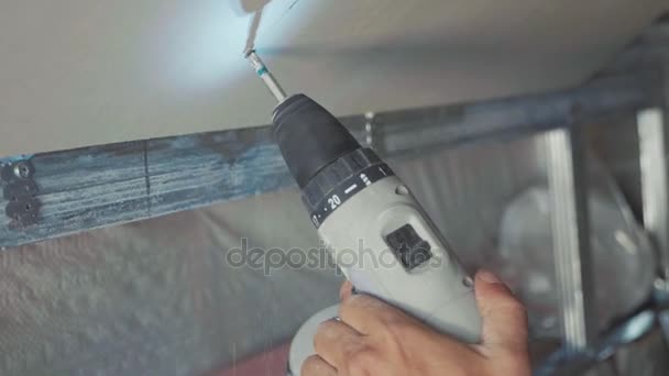 Worker make install drywall and using screwdriver and screw for work, closeup — Stock Video