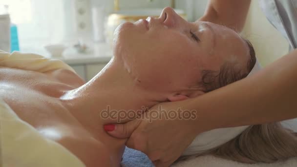 Attractive female at spa health club getting a facial massage — Stock Video