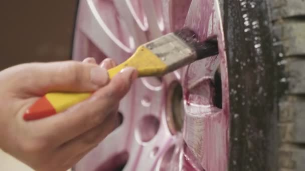 Man using chemistry for cleaning sport car wheel, slow motion — Stock Video