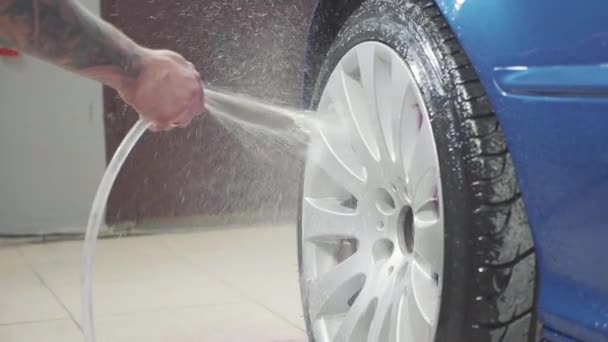 Man using chemistry for cleaning sport car wheel, slow motion — Stock Video
