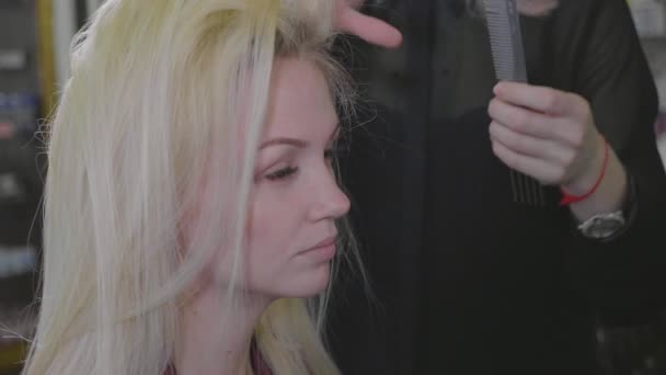 Молодая красивая парикмахерская девушка добавить объем прическу красивой клиентке . — стоковое видео