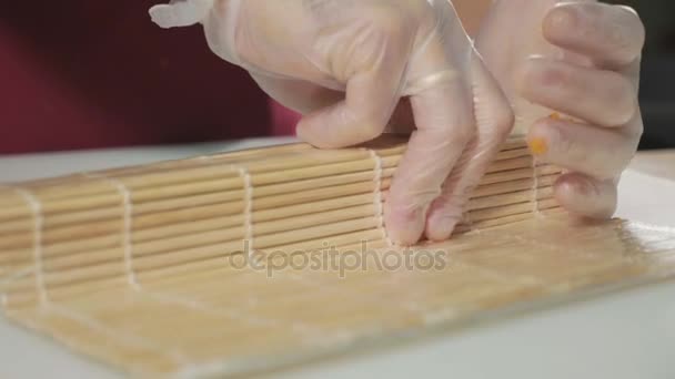 Professional sushi chef preparing roll at commercial kitchen, close-up. — Stock Video