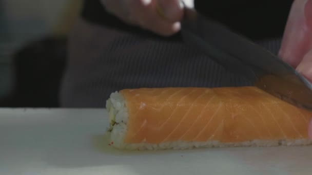 Professional sushi chef preparing roll at commercial kitchen, close-up. — Stock Video