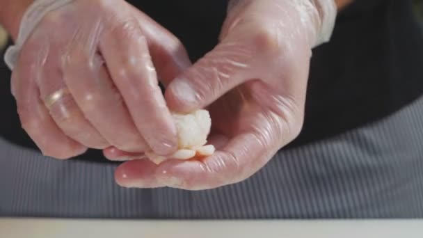 Macro shot of chefs hands making a sushi. — Stock Video