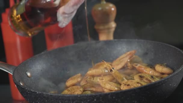 Chef pouring alcohol in pan with frying shrimps, close-up slow motion — Stock Video