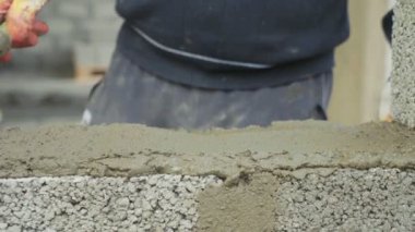 İnşaat işçisi tuğla duvar, inşaat sahasında closeup görünüm oluşturur