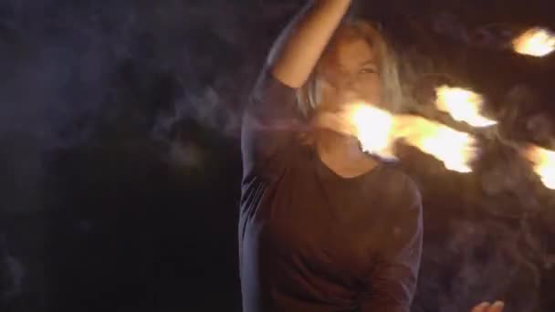 Yong woman artist performing fire show at dark in slow motion. — Stock Video