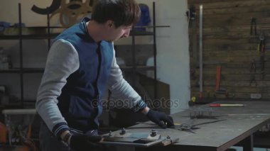 Metal dekoratif detay ile onun atölyesinde çalışan demirci