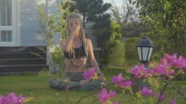 Pranayama yoga nefes egzersiz evinin arka bahçesinde genç bir kadın tarafından.