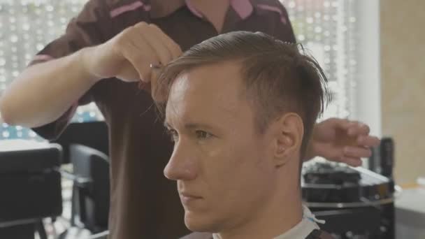 Gros plan de coiffeur peigne client masculin à la main après la coupe de cheveux au ralenti . — Video