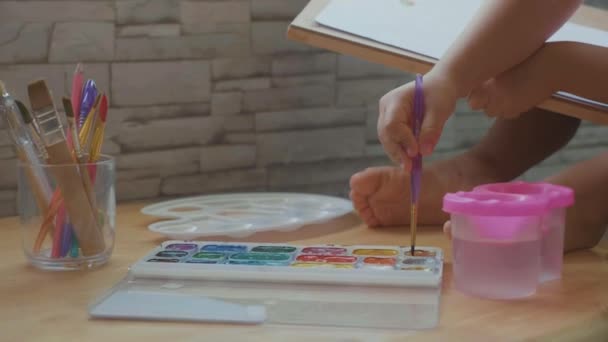 Child girl drawing by watercolor at home in slow motion. — Stock Video