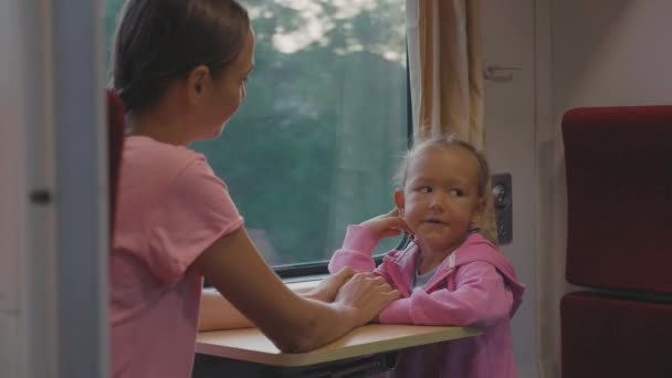 Familia pasando el tiempo en viaje en tren en Asia, mirando a la ventana y hablando — Vídeo de stock