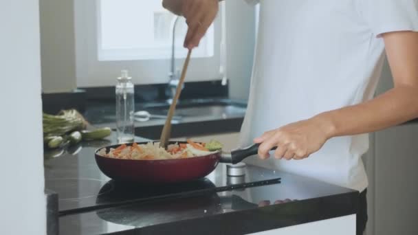 Vrouw mengen ingrediënten groenten op de koekenpan, close-up in slow motion — Stockvideo