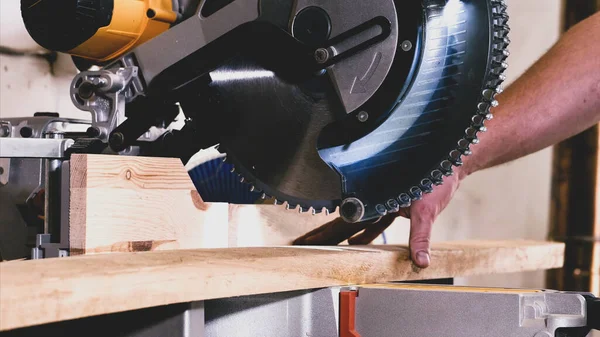 Closeup of stationary circular saw is sawing a wood on joinery factory. — Stock Photo, Image