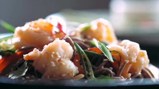Skivad chili faller på traditionella asiatiska soba stir-fry nudlar med räkor — Stockvideo