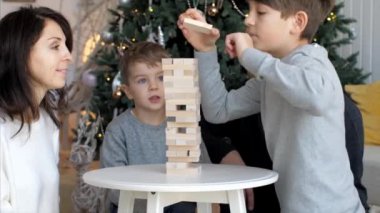Family is playing in wooden tower at home