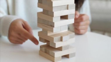 Family is playing in wooden tower at home