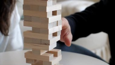Family is playing in wooden tower at home