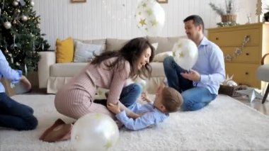 Large family with three children is having fun at home in Christmas eve