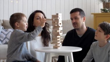 Family is playing in wooden tower at home