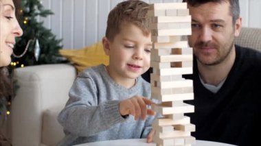 Family is playing in wooden tower at home