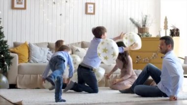 Large family with three children is having fun at home in Christmas eve