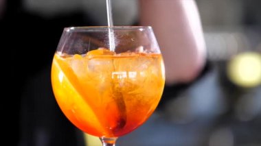 Barman is making alcohol cocktail, close-up