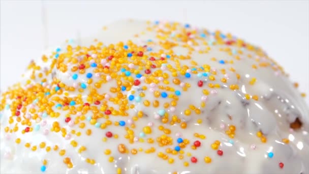 Confetti is sprinkles on top of Easter Cake with white glaze, close-up. — Stock Video