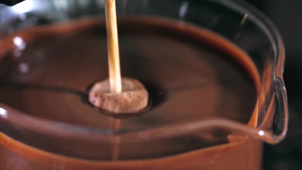 Bakers hands dip candies in melted chocolate. — Stock Video