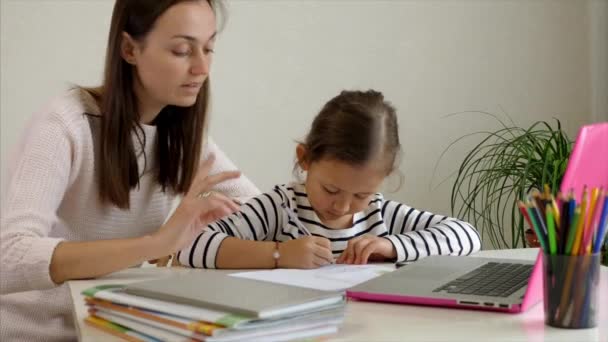 Tired mother helping daughter to do homework — Stock Video