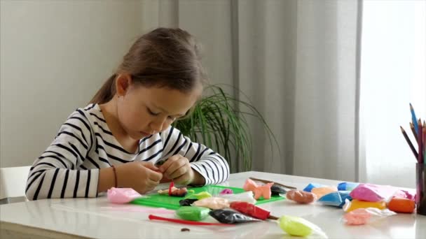 Ethnic girl playing with modelling clay — Stock Video