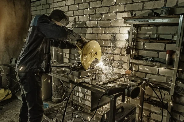 Werknemer houdt handen de metall-pijp snijden op de machine. Tegen de achtergrond van witte bakstenen — Stockfoto