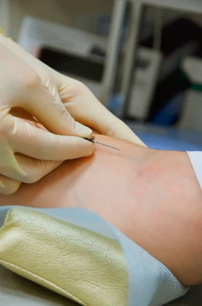 In a patient in the clinic, blood is taken from a vein. in the frame of the syringe and needle nurse hands — Stock Photo, Image