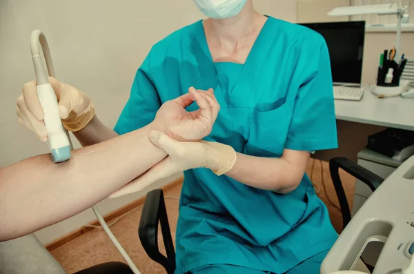 Detail of male using ultrasound probe on senior males wrist — Stock Photo, Image