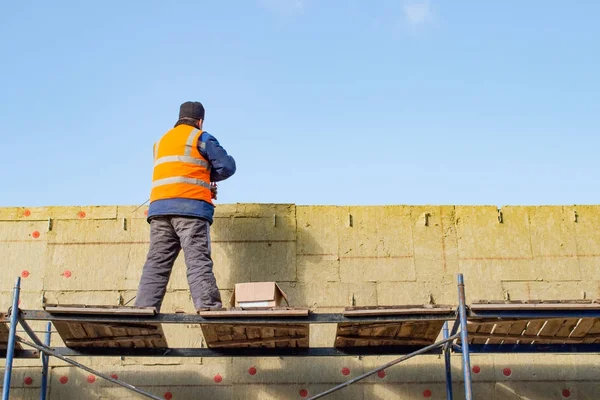 İşçinin ısıtıcı duvara koyar.