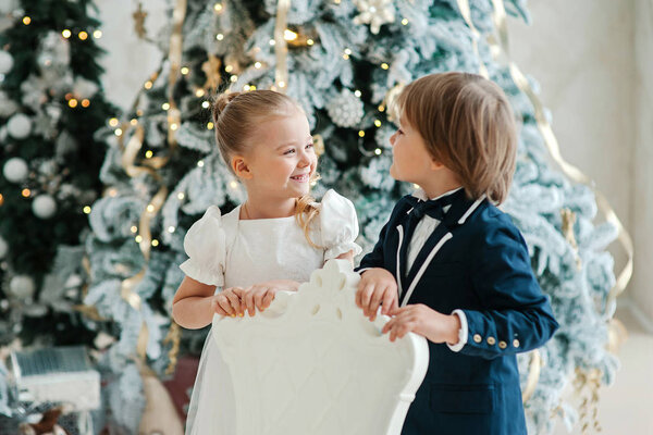 girl with boy putting hands on armchair